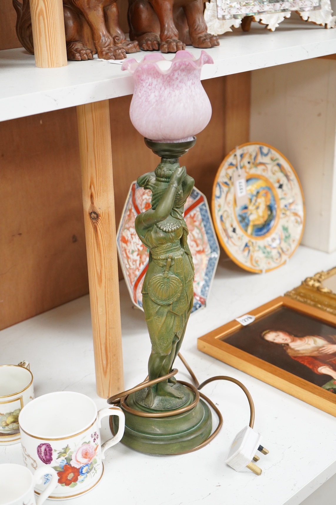 A composite lamp in the form of a female figure, with pink fluted glass shade, 50cm high overall